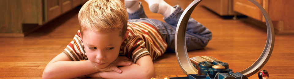 A young child playing with comfort in his temperature controlled, gas furnace home